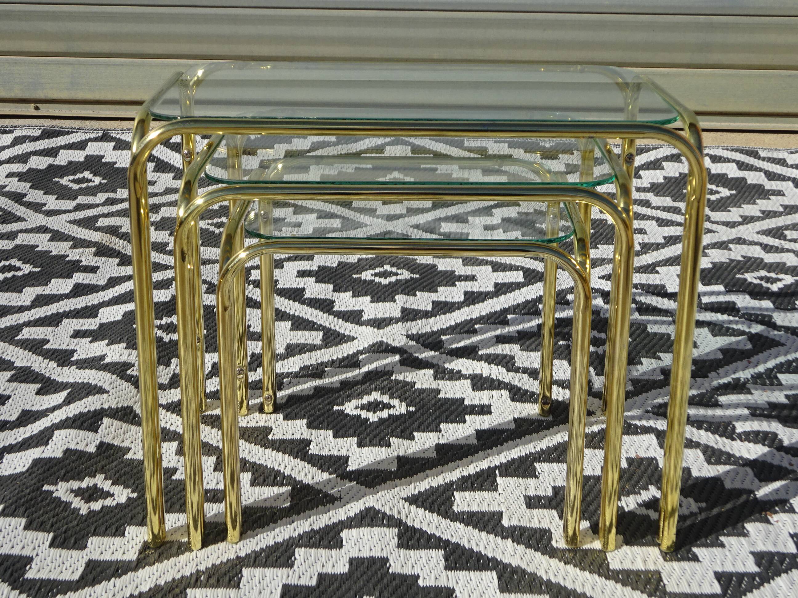 Nesting tables in gold-tone metal and glass