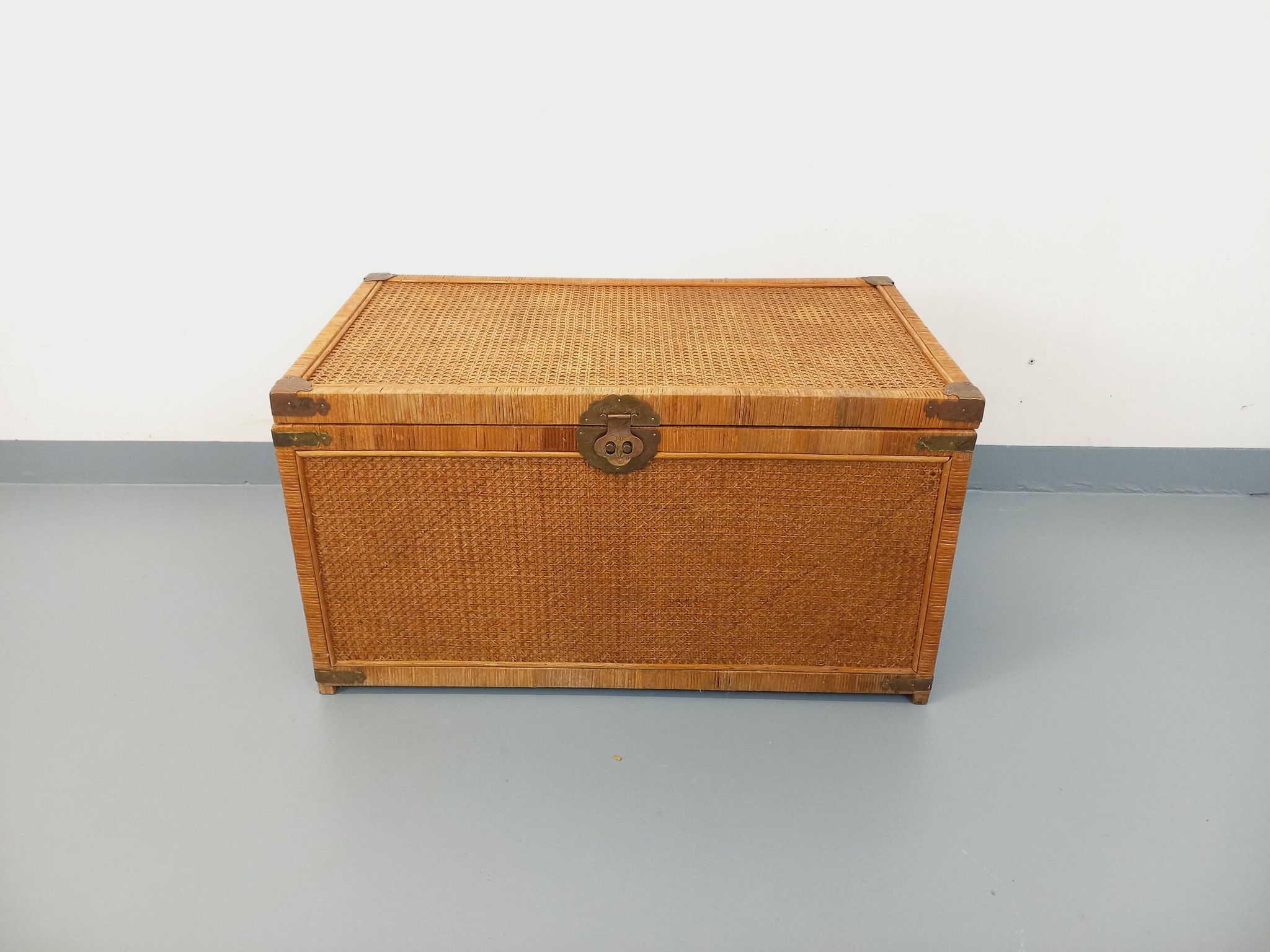 Vintage trunk in wood, rattan, caning, and brass.