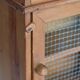 Vintage wooden shelf with drawers and mesh door.
