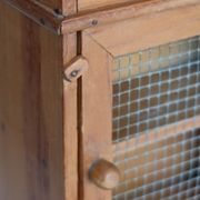 Vintage wooden shelf with drawers and mesh door.