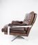 Easy chair upholstered with patinated brown leather and frame in metal, designed by Arne Norell