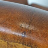 Sheepskin leather wingback armchair, with nails and black piping