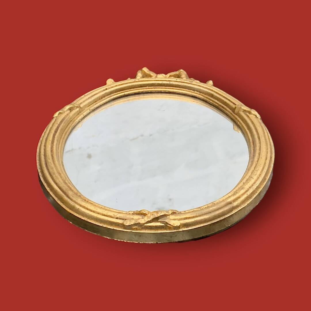 Antique oval mirror in gilded resin with Louis XVI style knot decoration