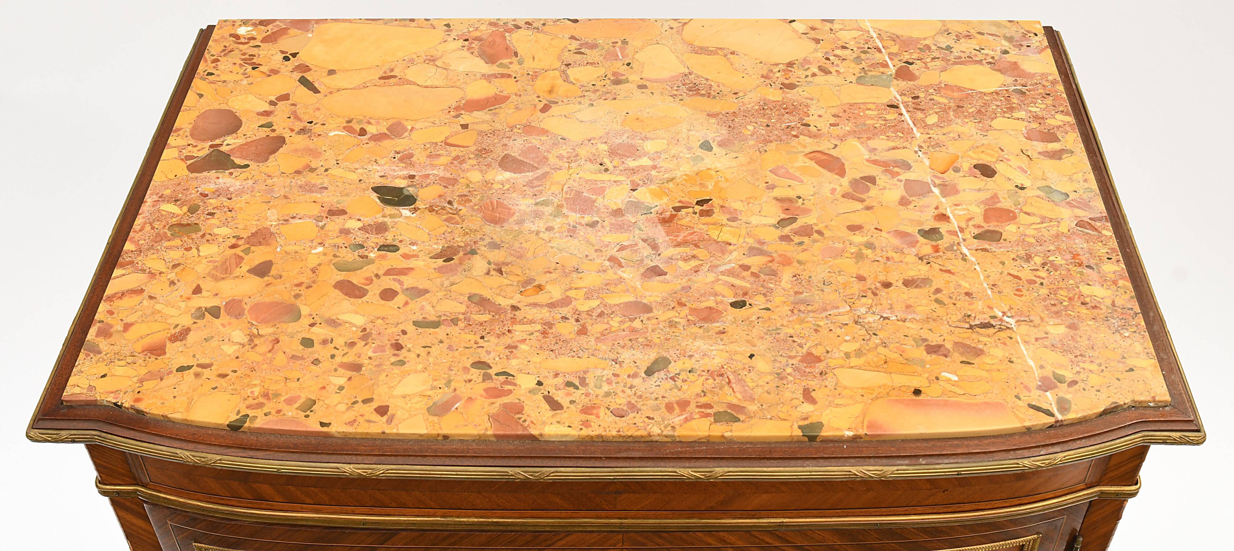In-between furniture in marquetry decorated with a trophy decoration of musical instruments