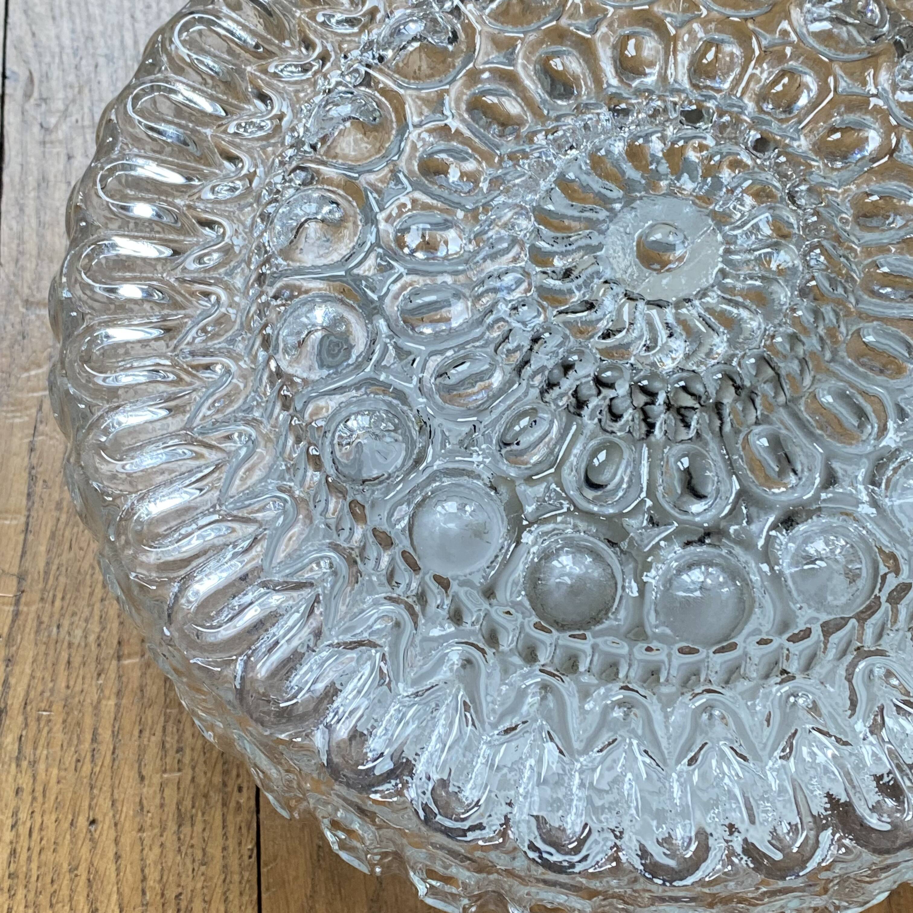 Large wall-mounted ceiling light with transparent glass.