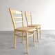 Paire chaises Baumann bois clair et cannage