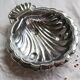 Vintage shell-shaped shiny silver-plated catchall.