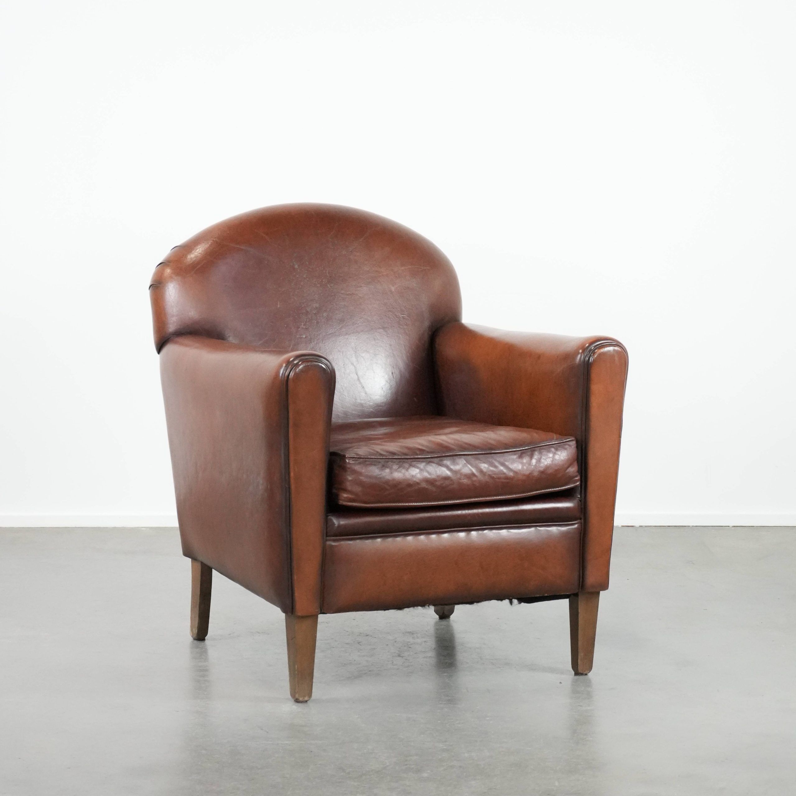 Armchair made of sheepskin leather in art deco design with warm colours