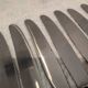 12 silver-plated metal dessert knives with rocaille ribbon decoration, 21.4 cm
