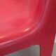 Four red fibreglass chairs from the 1970s.
