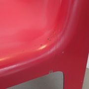 Four red fibreglass chairs from the 1970s.