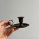 Small antique candle holder in patinated metal