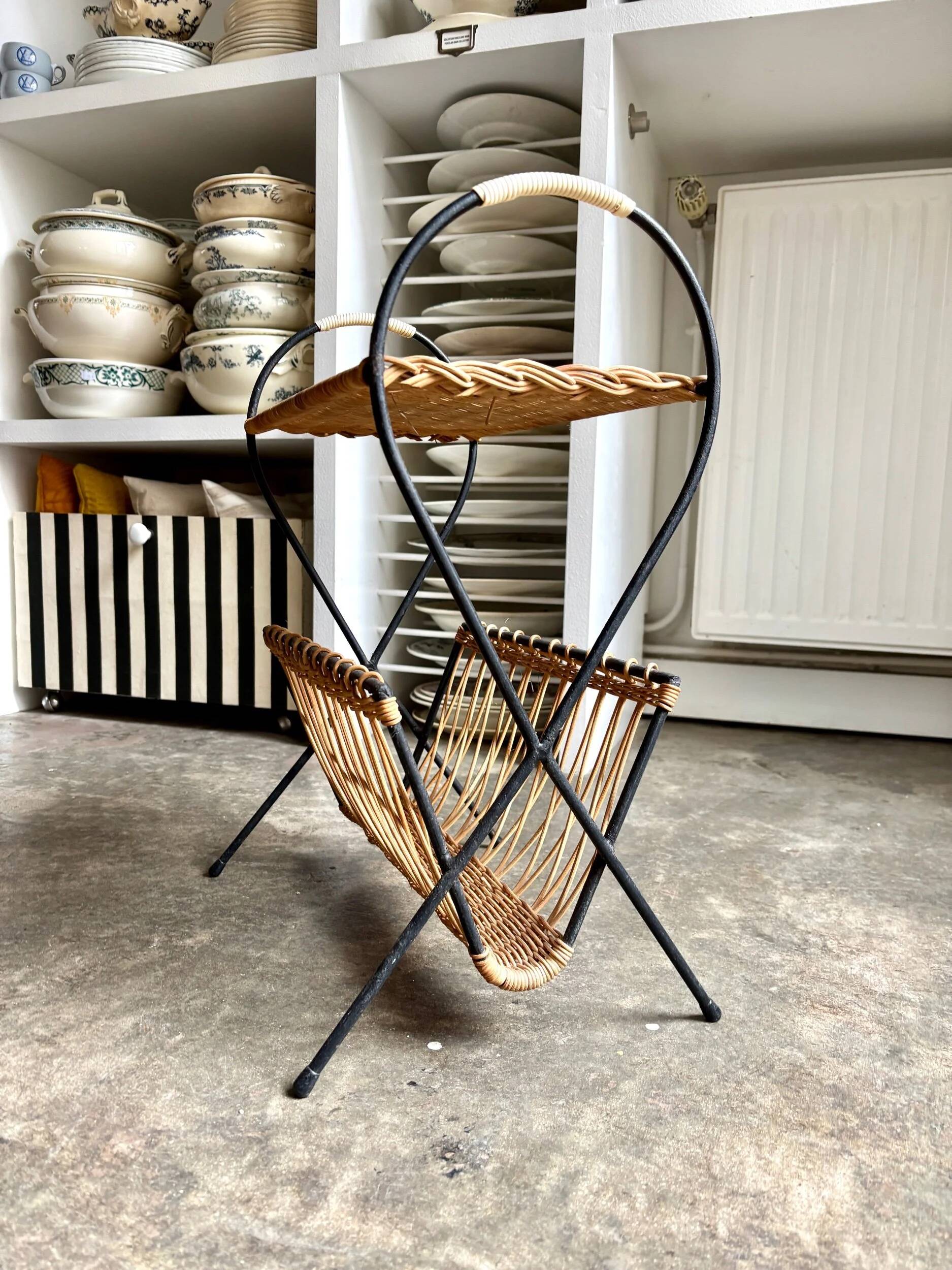 Black metal and woven wicker magazine rack