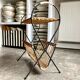 Black metal and woven wicker magazine rack