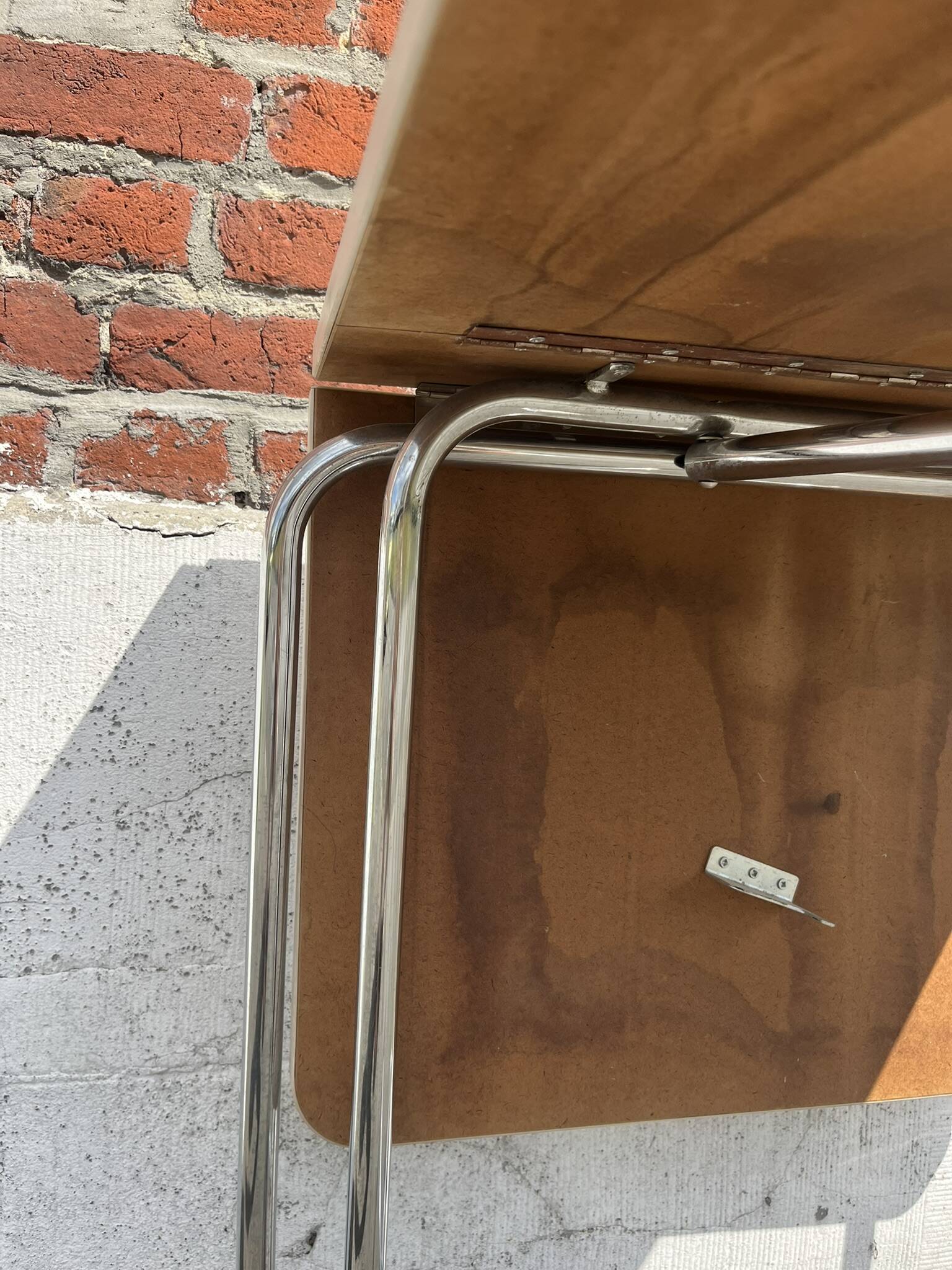 Folding table with chrome and pink formica.