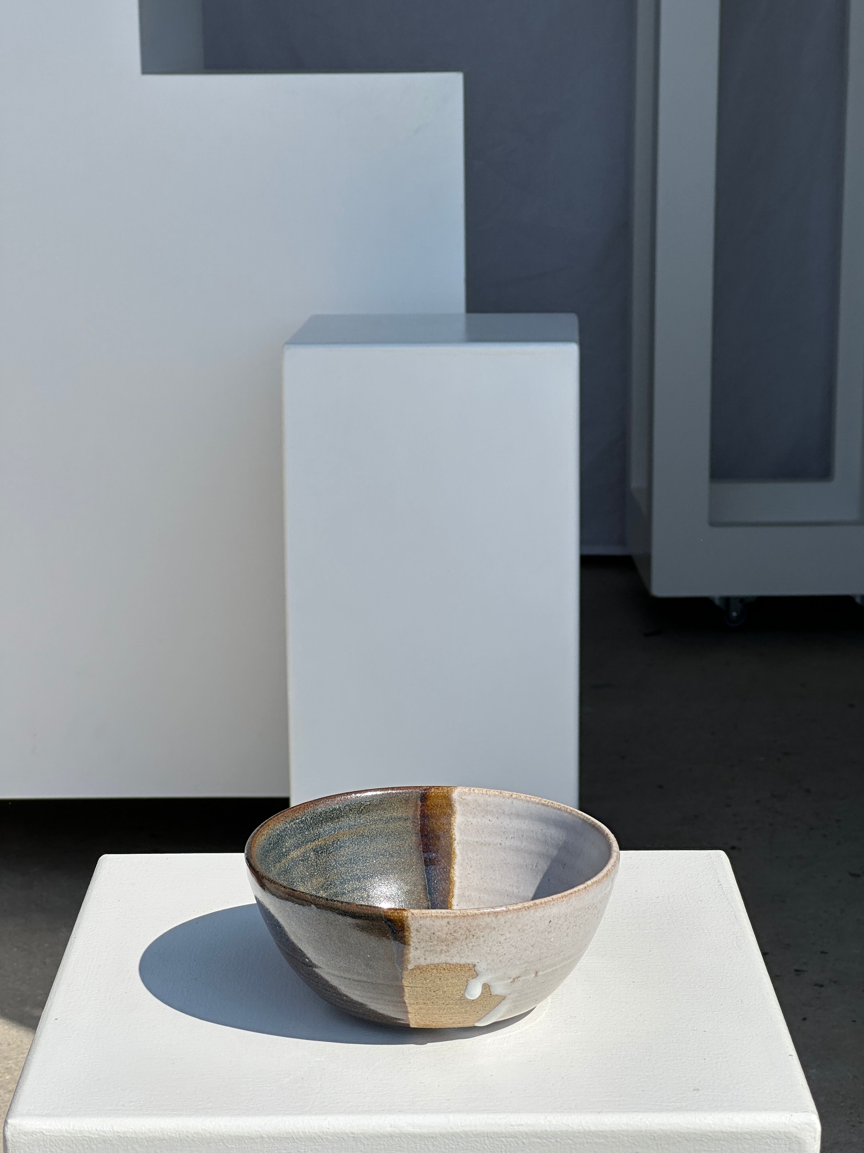 White and glossy brown two-tone ceramic bowl, matt earth