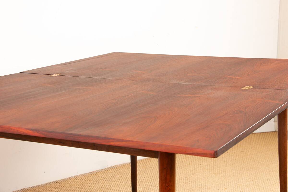 Danish extendable dining table in rosewood and brass by Poul Volther