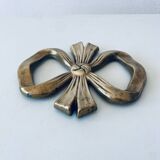 Bow-shaped brass trivet