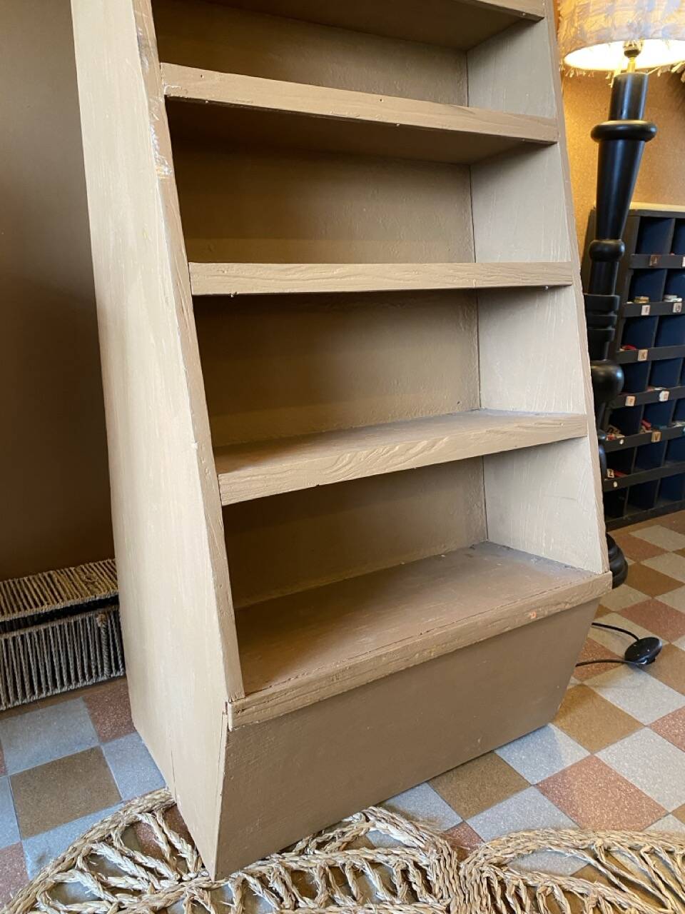 Painted wooden display shelf with an incline