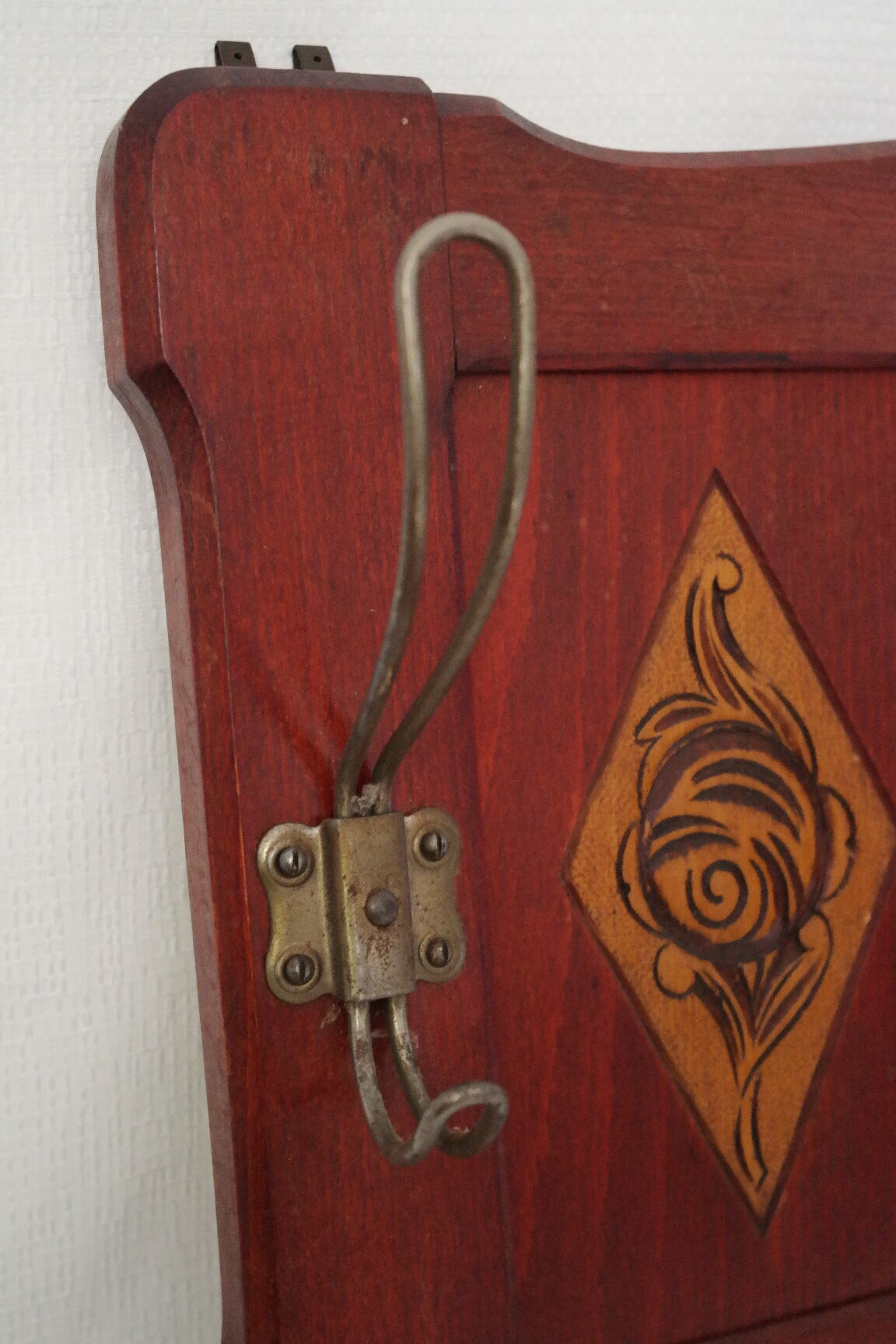 Red wooden wall-mounted coat rack and Art Deco mirror