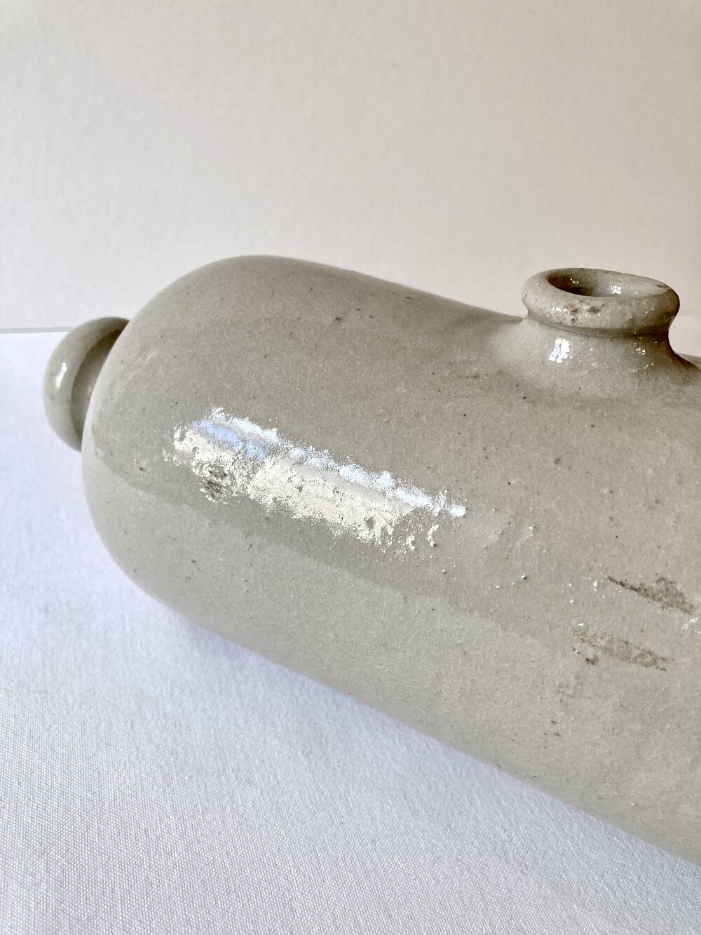 Old horizontal glazed stoneware hot water bottle, late 19th century.