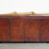 Luxurious and spacious two-seater sheepskin sofa of top quality with fabric cushions