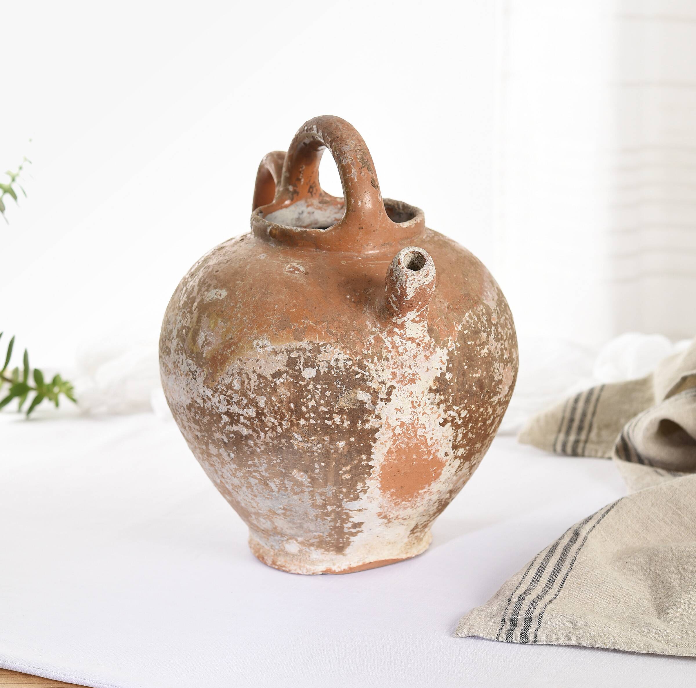 Old water jug. Gargoulette. Old terracotta pitcher.