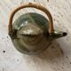 Handmade ceramic teapot with green fish and bamboo