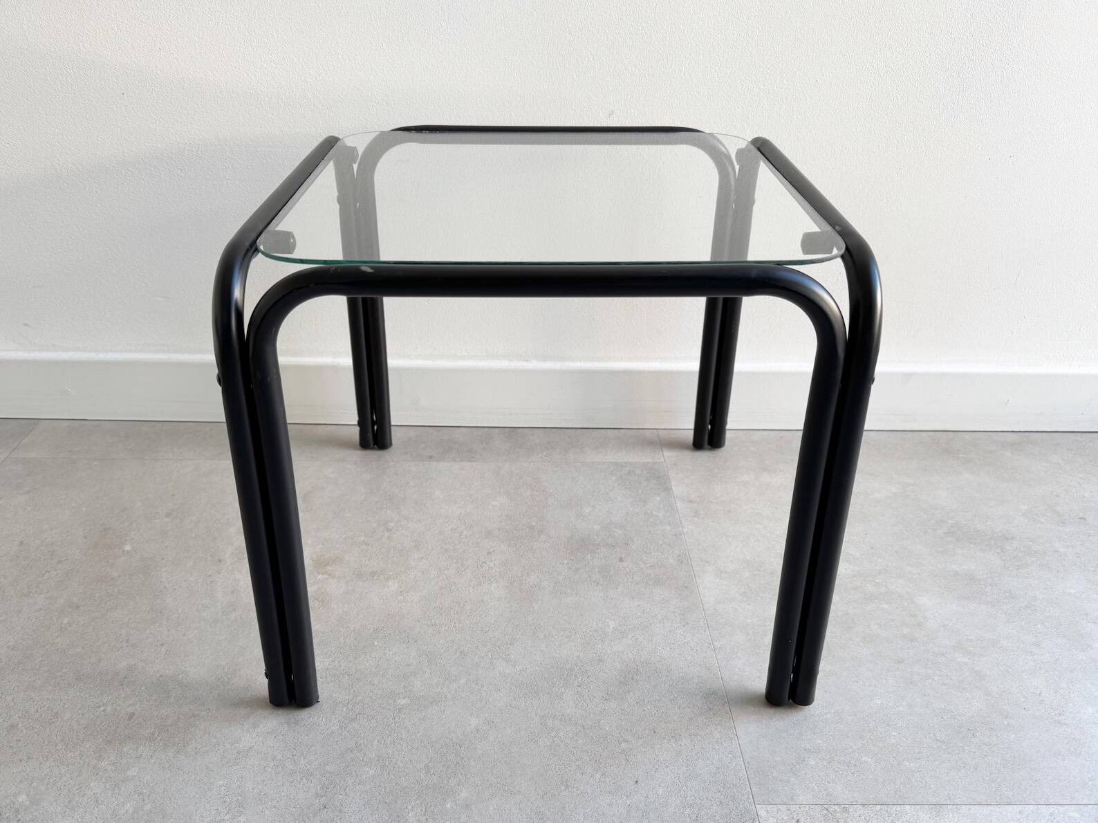 Vintage square black side table with a glass top