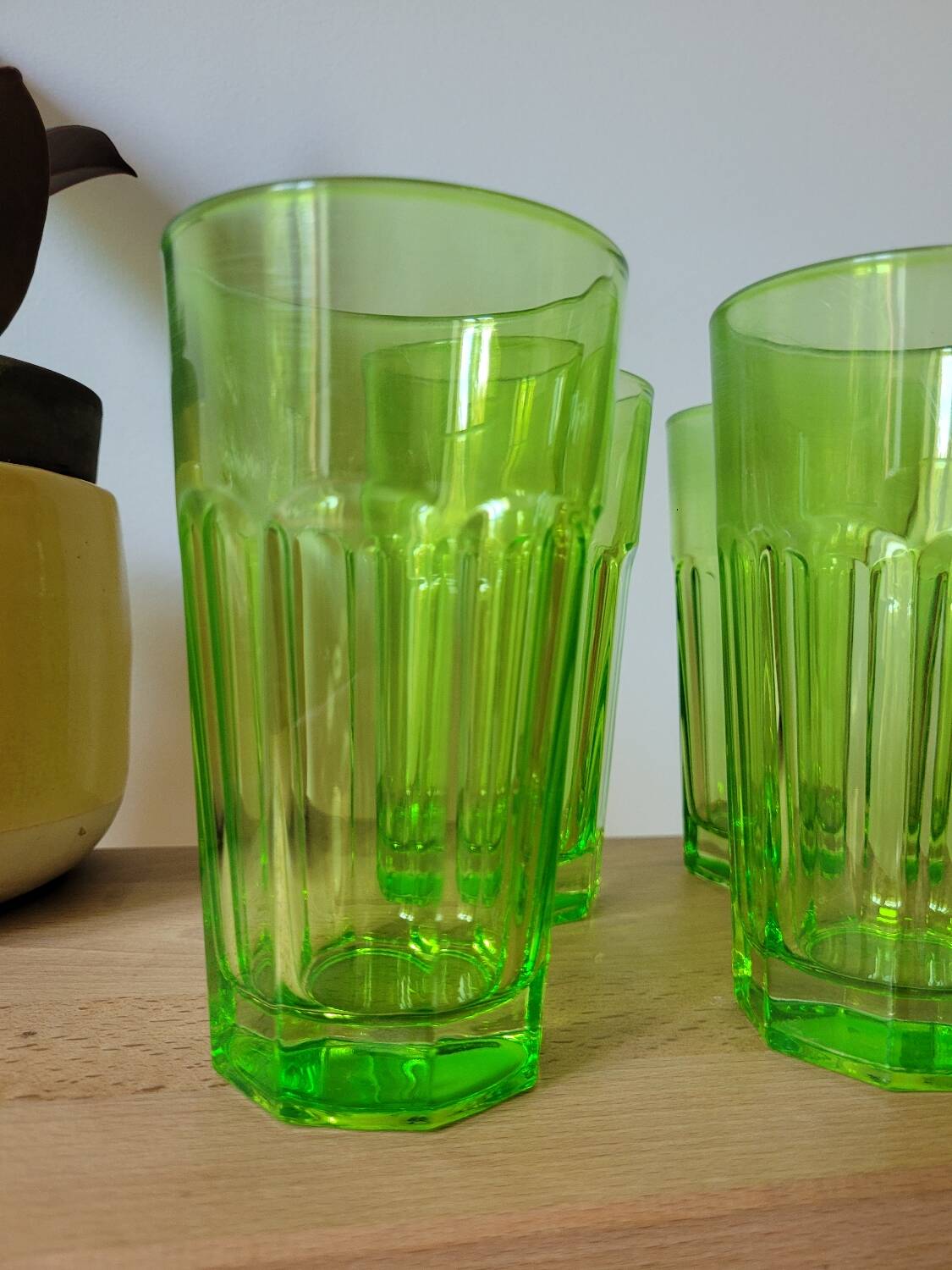 Four neon green lemonade glasses