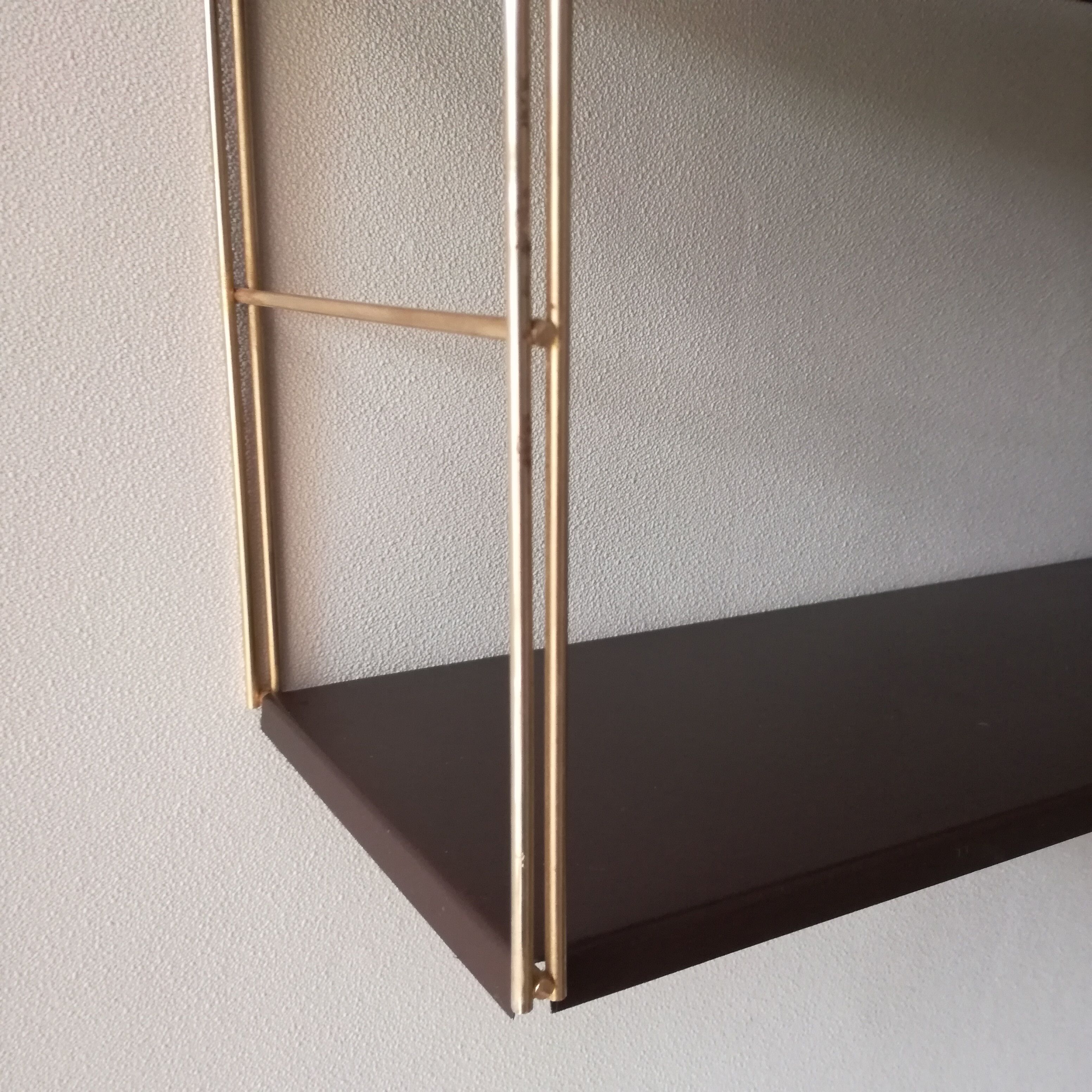 Golden and brown stringed shelf in metal