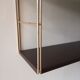 Golden and brown stringed shelf in metal