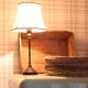 Table lamp with a patinated base and vintage woven shade.