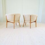 Mid-century lounge chairs in sheepskin/shearling and stained wood, Sweden, 1962.