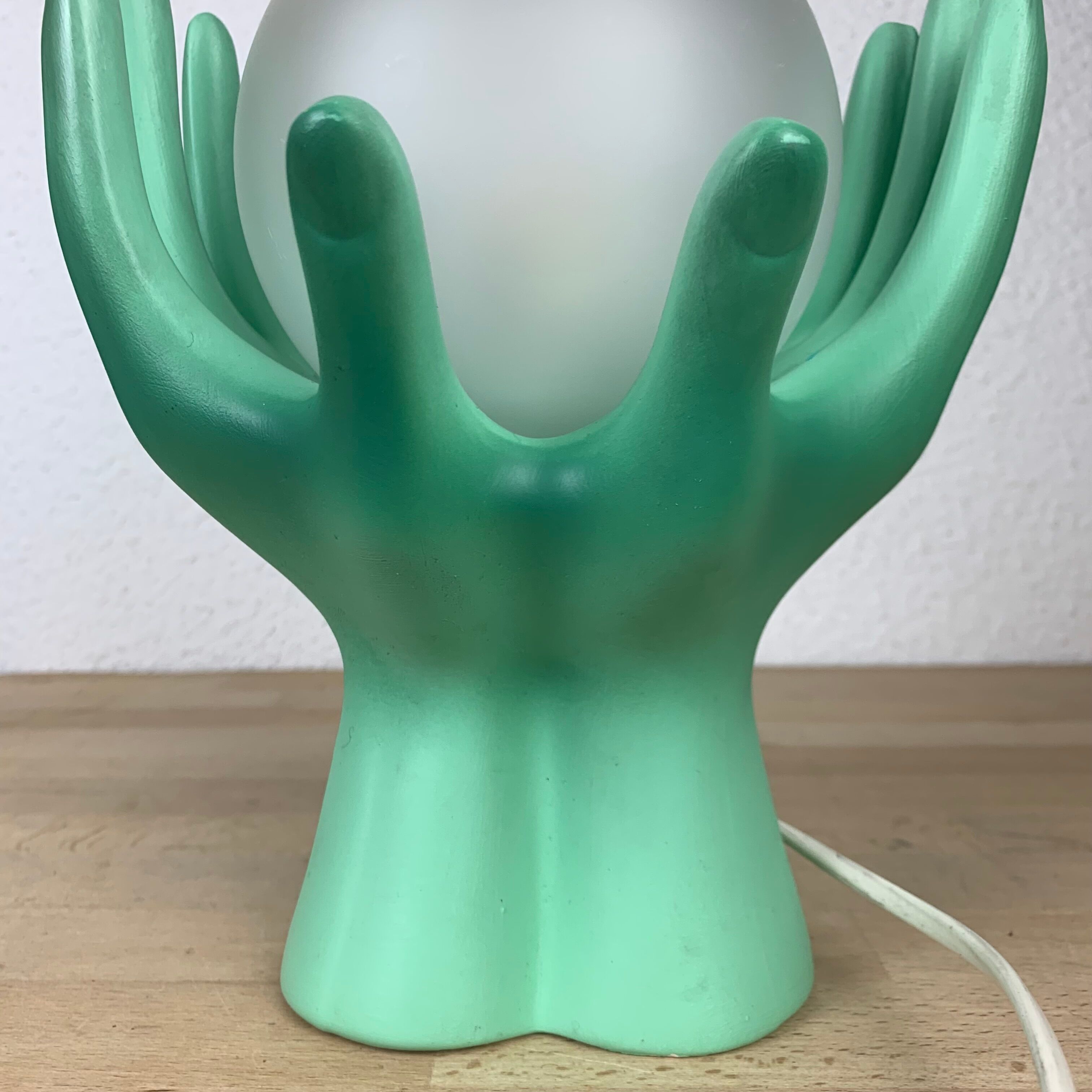 Green ceramic hand lamp and glass globe