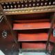 Small antique side table in carved wood.