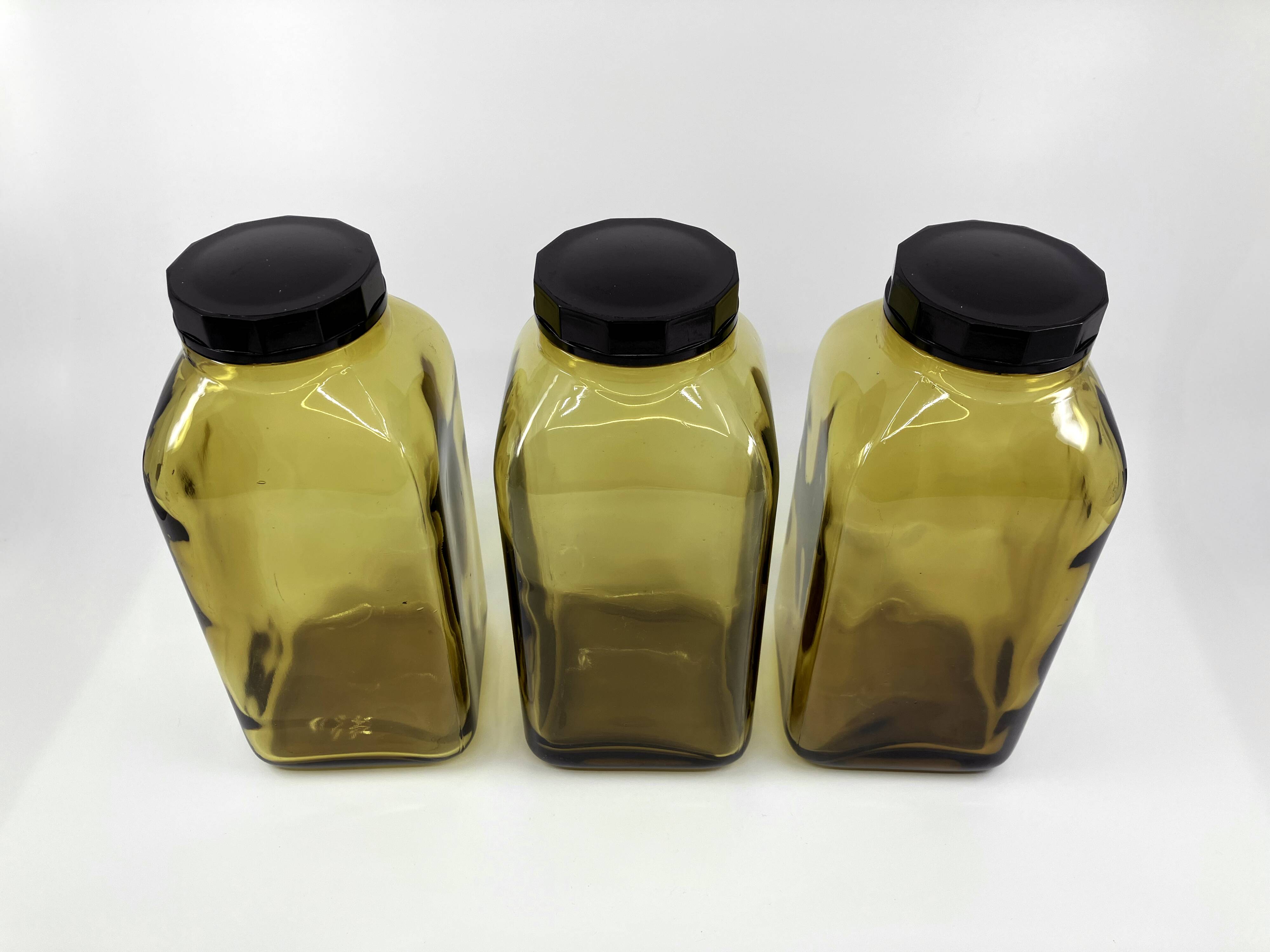 3 molded amber glass pharmacy bottles • Bakelite stoppers • 1950