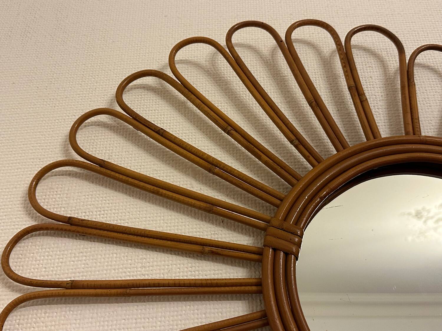 Old vintage asymmetrical round rattan mirror