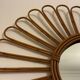 Old vintage asymmetrical round rattan mirror