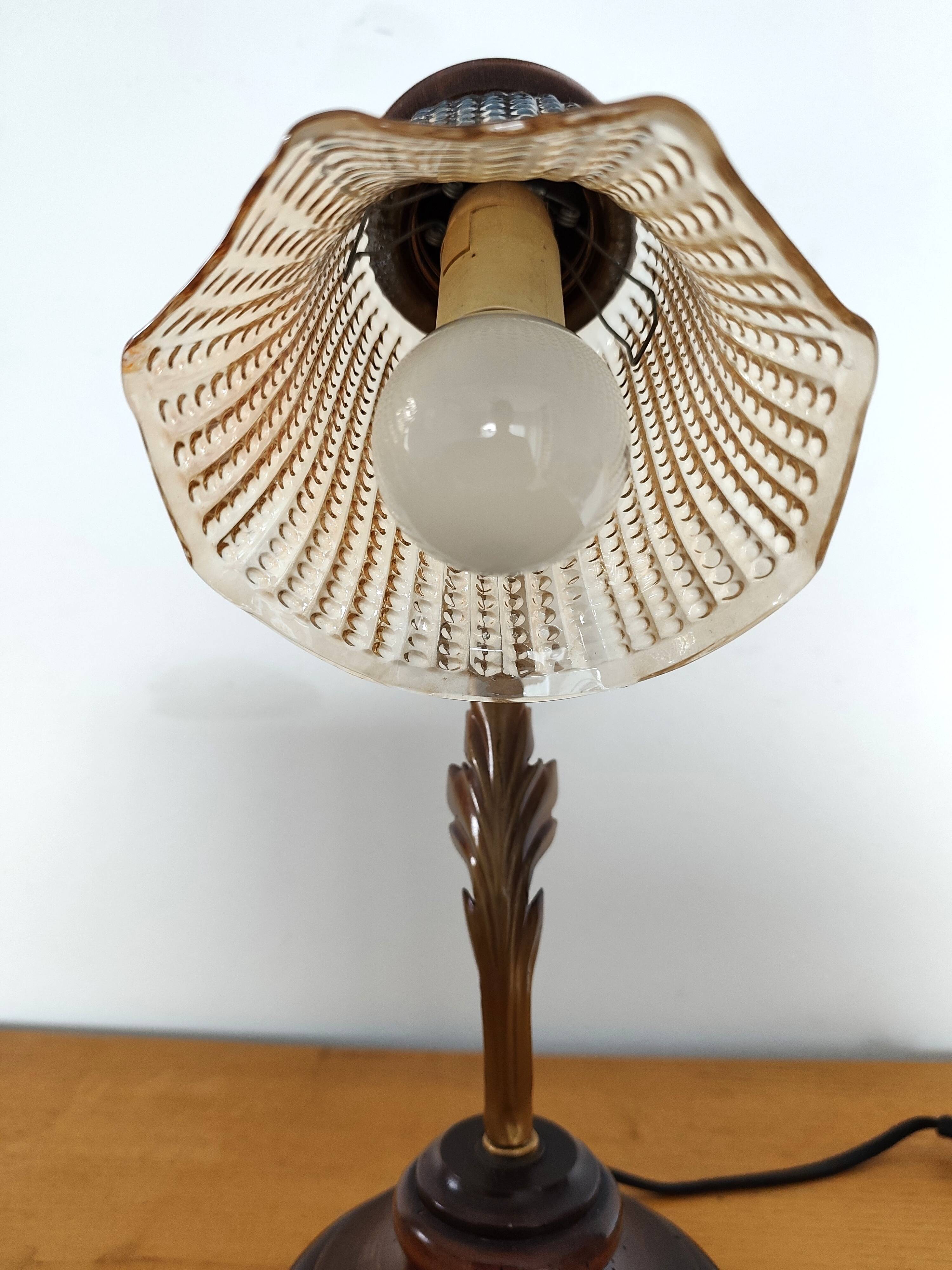 Gold swan neck table lamp with amber tulip glass.