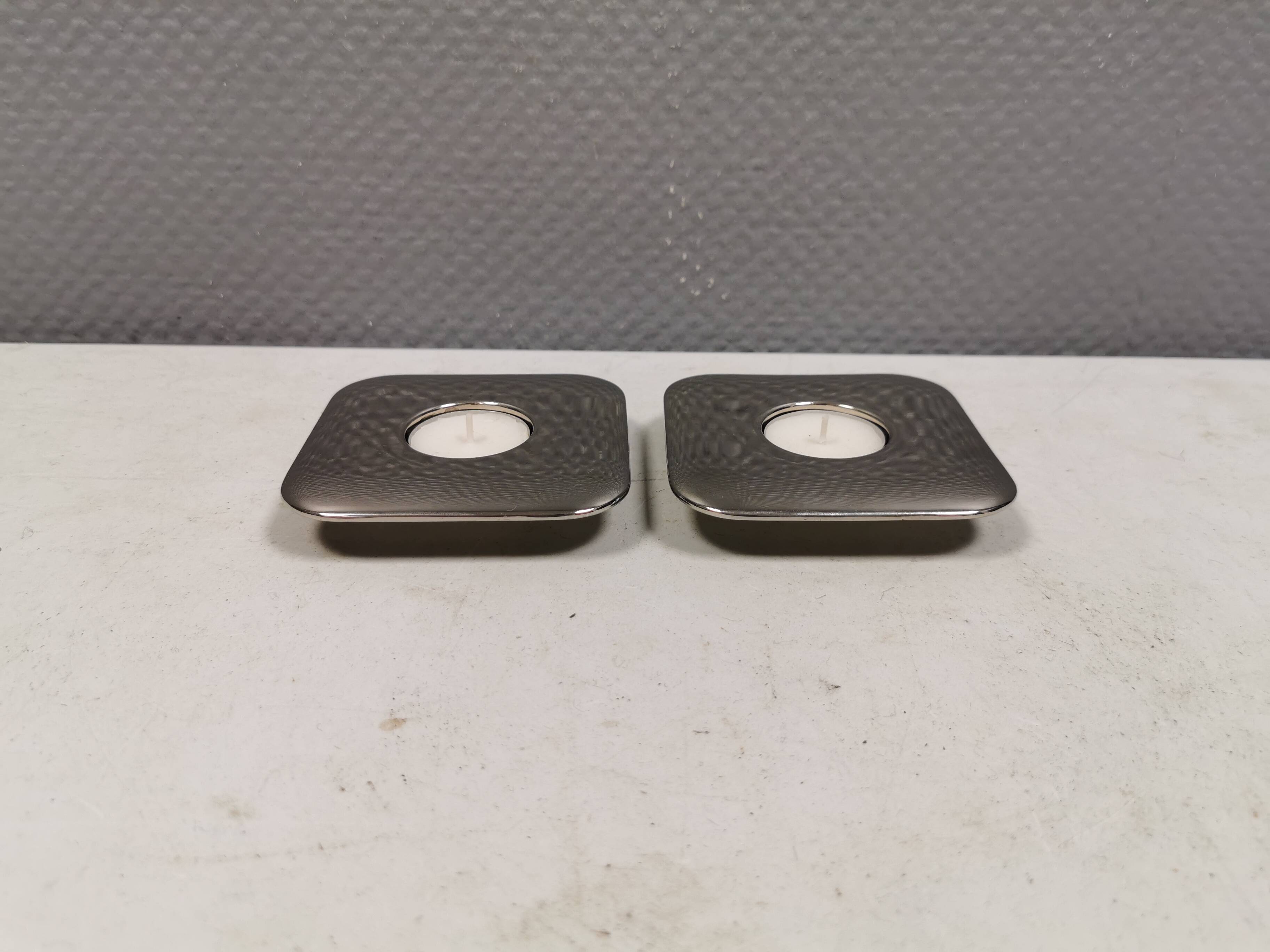 A set of classic Danish candlesticks in polished metal.