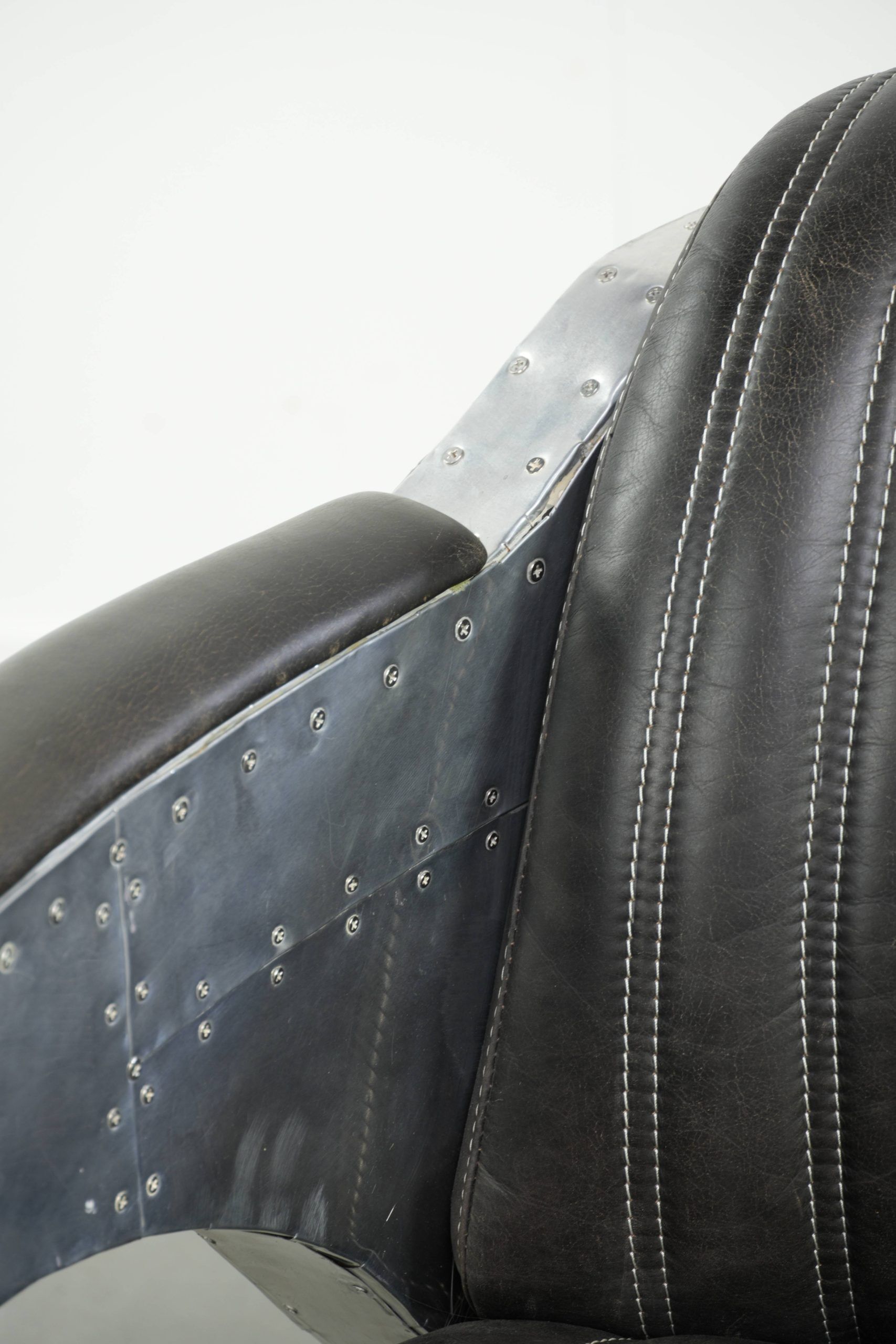 Cow leather aviator design armchair finished with aluminium and rivets