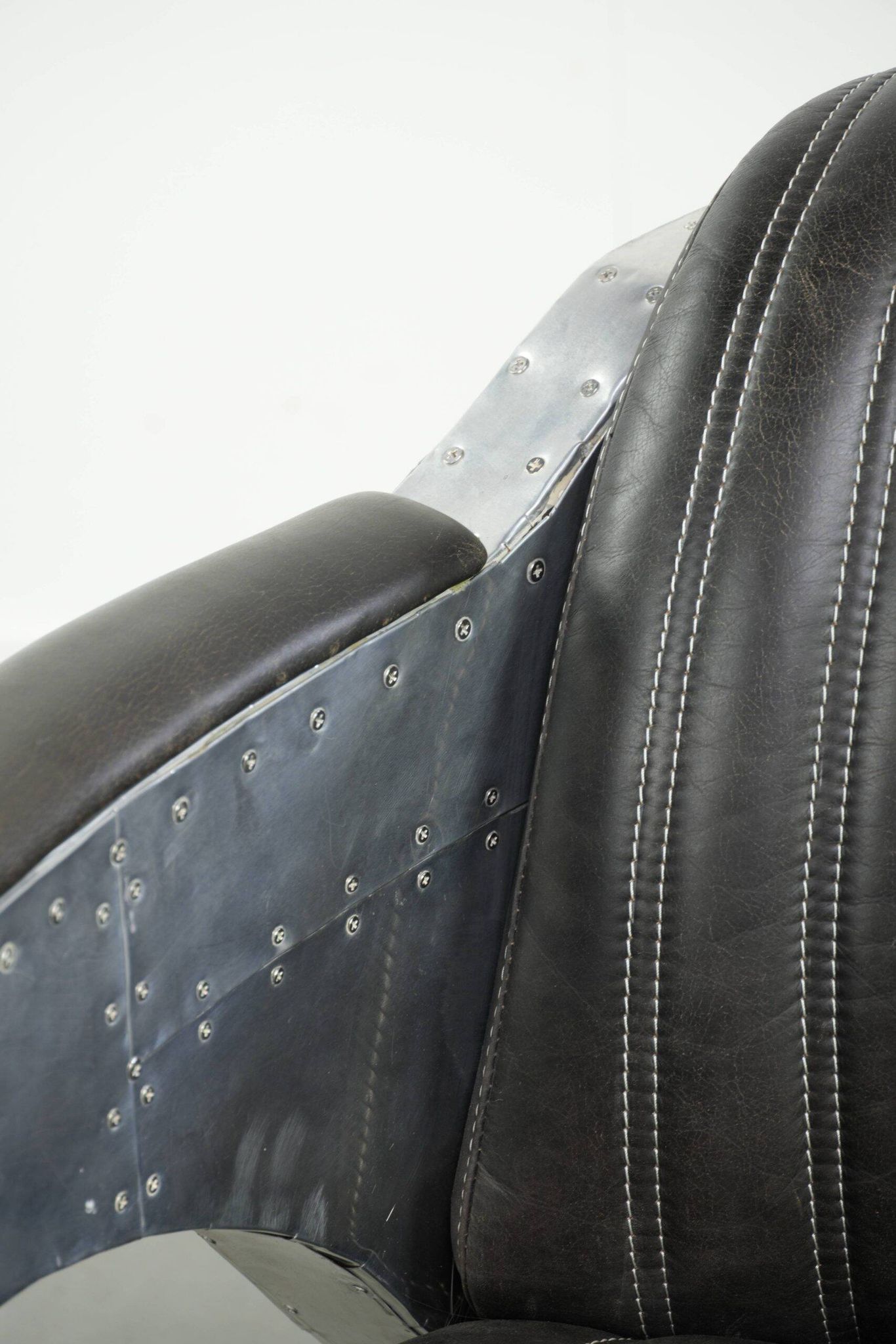 Cow leather aviator design armchair finished with aluminium and rivets