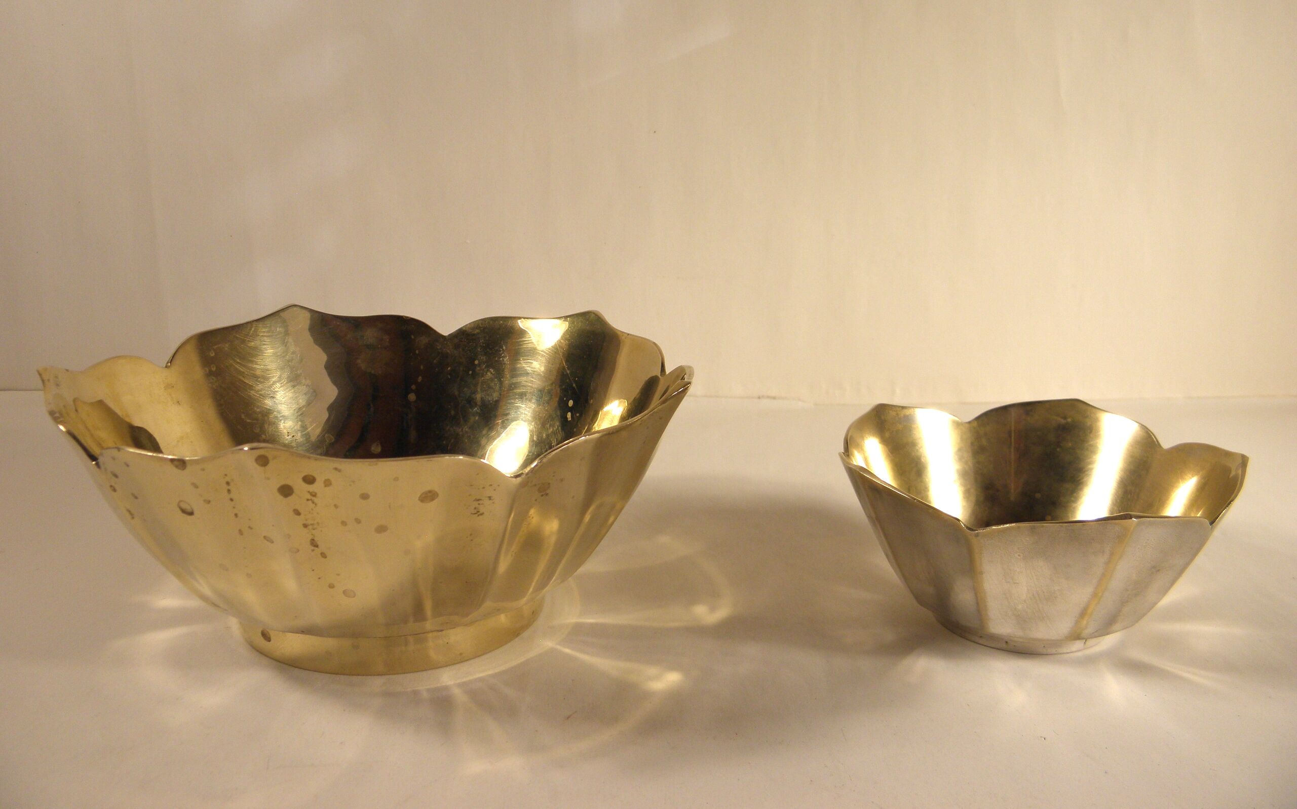 Two brass trundle cups