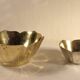 Two brass trundle cups