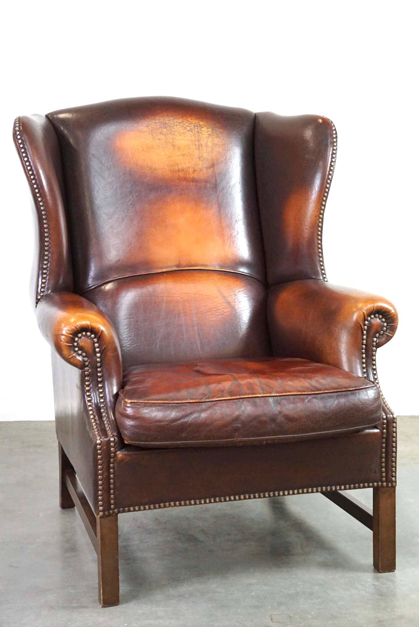 Beautiful classic and stately wingback armchair made of sheep leather with beautiful colors