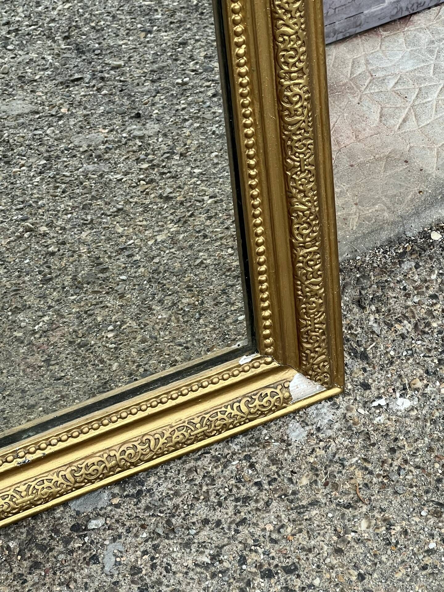 Louis Philippe mirror in gilded wood with an openwork frieze and mercury glass.