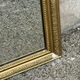 Louis Philippe mirror in gilded wood with an openwork frieze and mercury glass.