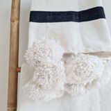Hand-woven plaid with black stripes and white pompoms