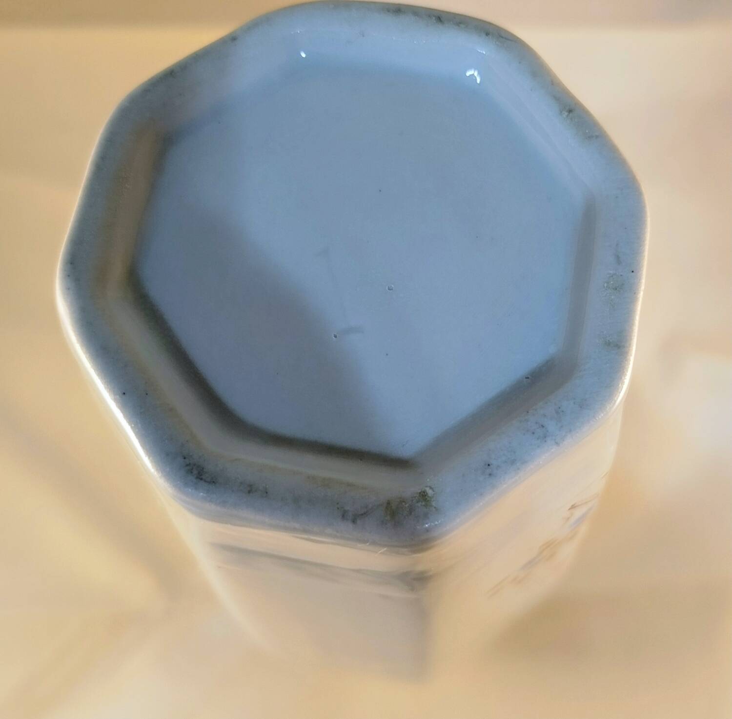 White ceramic vase with floral patterns